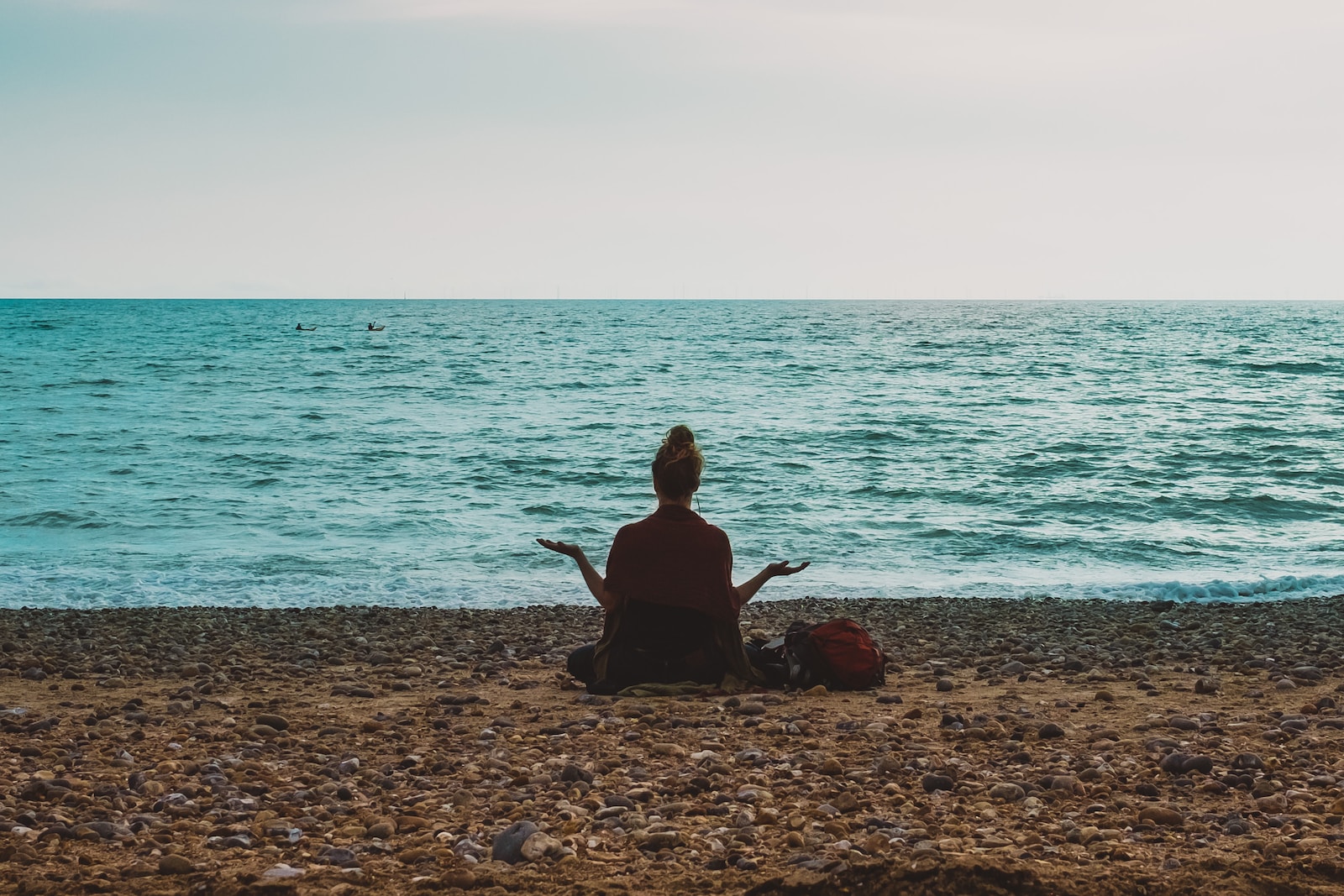 person doing yoga on seashore during daytime